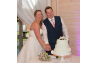newlywed couple cutting their wedding cake