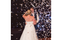 newlywed couple dancing in confetti