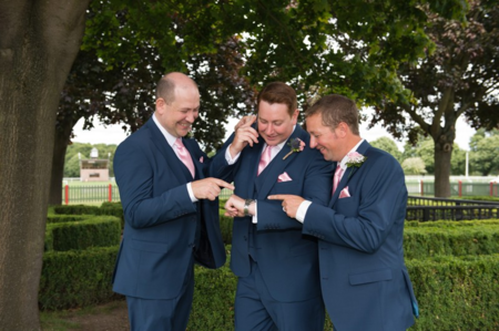 groomsmen checking out ring before wedding