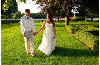 bride and groom walking through beautiful green landscape