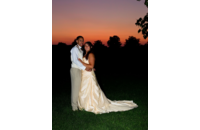 groom holding bride at sunset