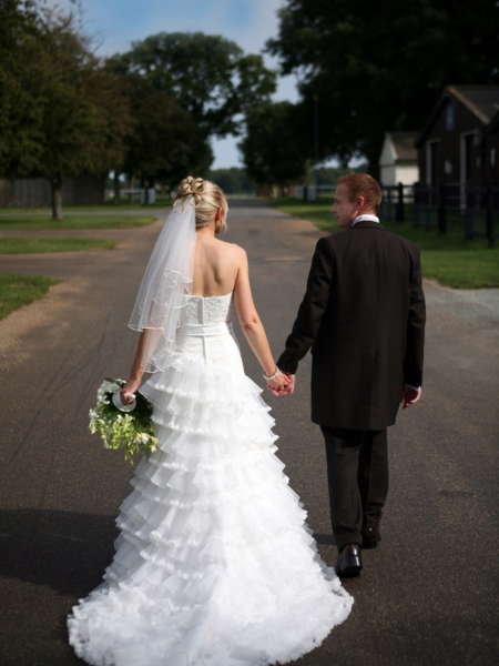 bride and groom walking off and holding hands