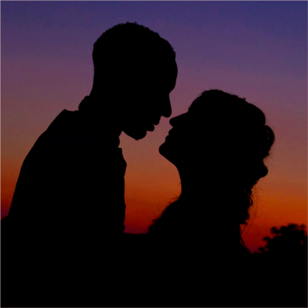 silhouetted couple at sunset