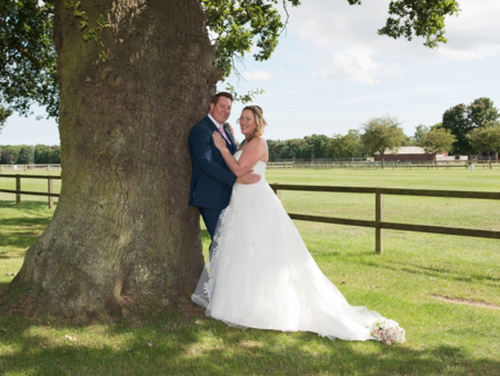 outdoor tree picture of newlywed couple